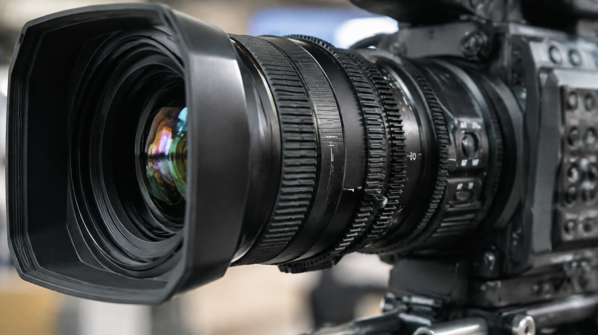 Close-up of a professional camera lens and settings dial